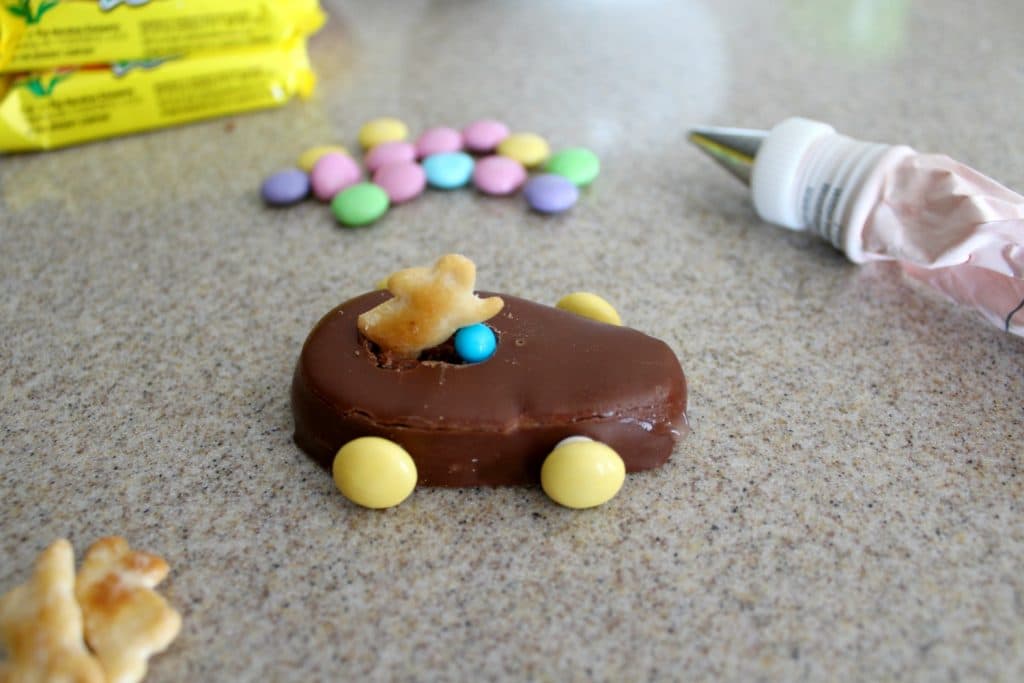 frosting is out and ready to attach m&ms to the peanut butter egg to make wheels and a steerng wheel