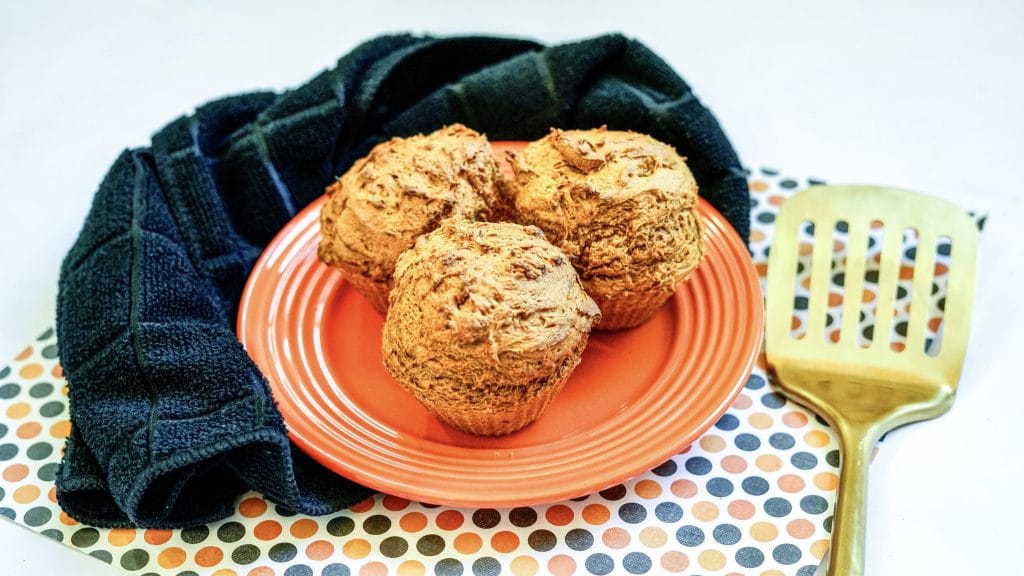 Pumpkin Muffins on an orange plate. These 2 ingredient pumpkin muffins were made in an air fryer.