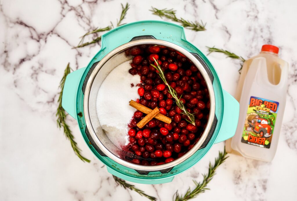 Pour apple cider over the cranberries and other ingredients in your Instant Pot and you're almost ready to make homemade Cranberry Sauce.