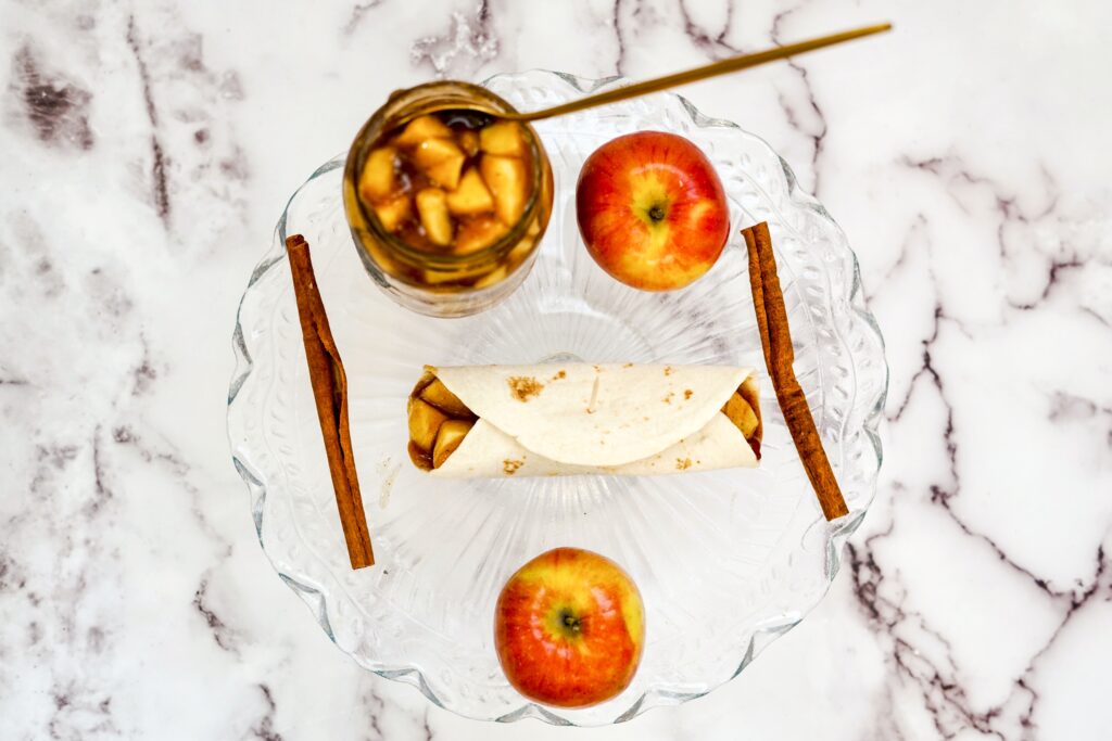 Baked Apple Pie Rolls an Easy Dessert Made with tortillas and glazed with cinnamon and sugar.